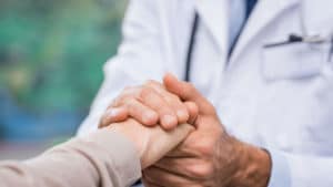 Doctor and Patient Touching Hands